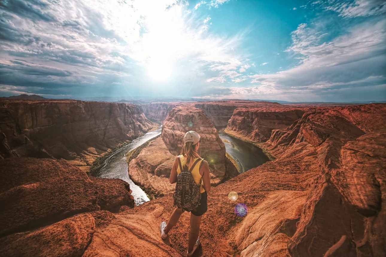 Woman overlooking Horseshoe Bend, Arizona scenery.